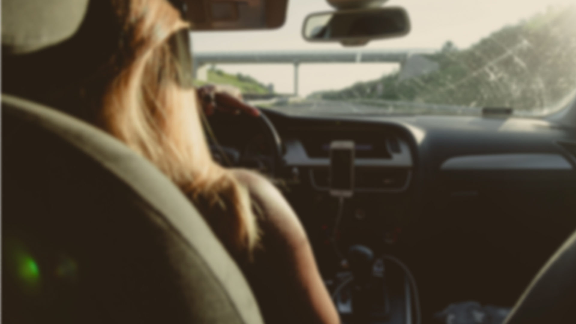 Why Onust Intro Photo Unfocused photo of a woman driving a vehicle on a freeway